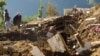 Pakistani villagers collect their belongings under the rubble of their homes destroyed from an earthquake in Shangla in Swat valley, Pakistan, Oct. 28, 2015. 