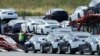 FILE - Tesla cars are loaded onto carriers at the Tesla electric car plant in Fremont, California, May 13, 2020. The Biden adminstration has made short-term emission reductions a top priority. 