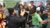 Syrian, Afghan refugees dance outside Vienna, Austria train station, Sept. 15, 2015.