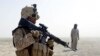 A U.S. Marine from 5th Battalion 10th Marines patrols with a member of an Afghan border guard unit in the desert of the lower Helmand River valley, in southern Afghanistan July 1, 2009. The United States has sent 8,500 troops to Helmand Province in the pa